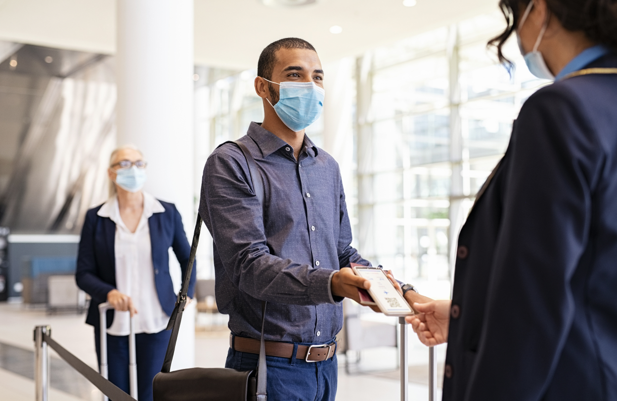 Traveler wearing a face mask at a check-in counter
