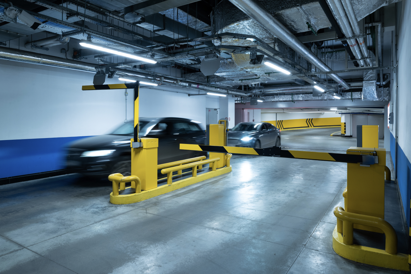 Car passing a barrier gate in a parking garage