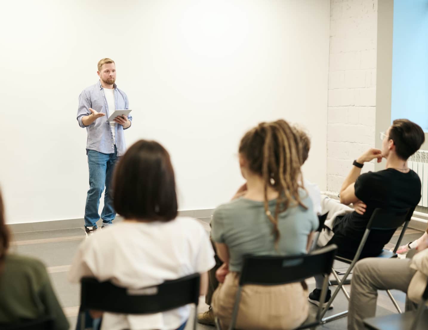 Presenter speaking to a seated audience