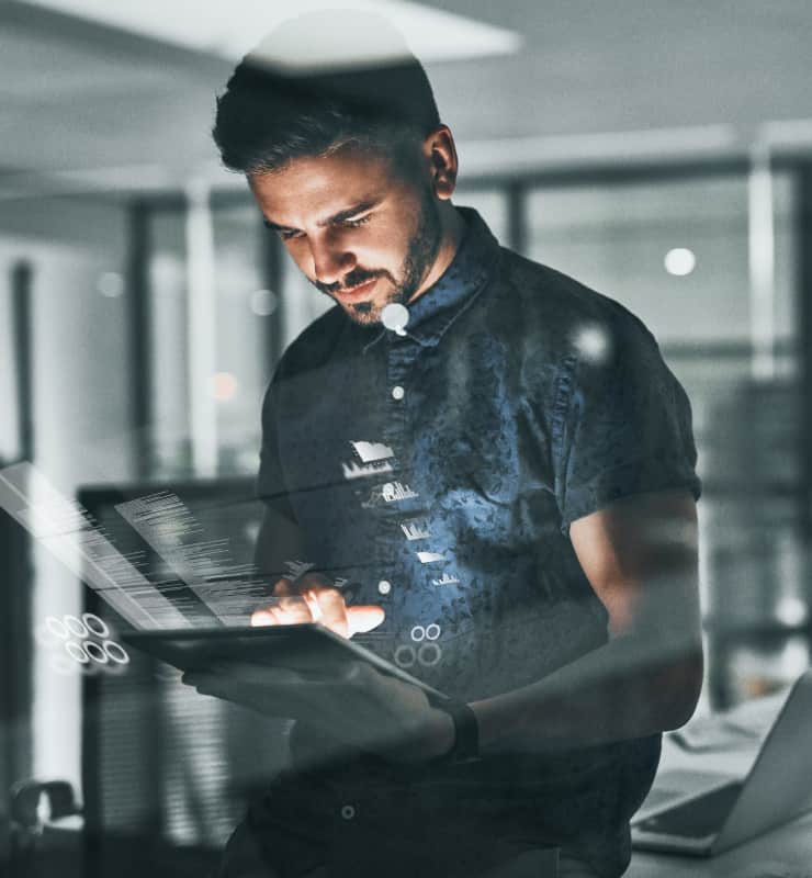 Developer working on a laptop in a dimly lit office