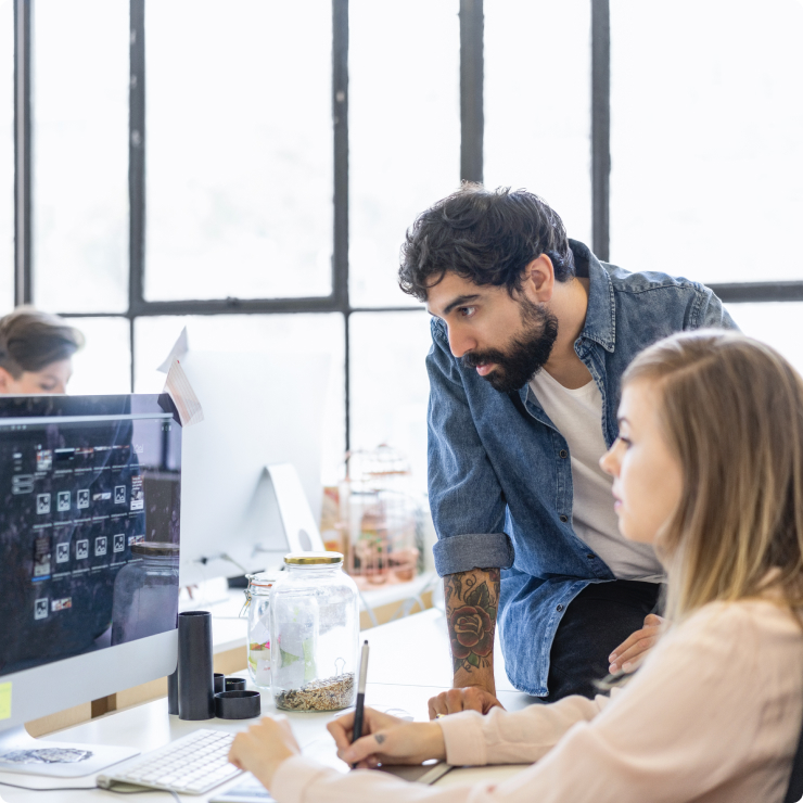 Colleagues discussing a project in a bright office