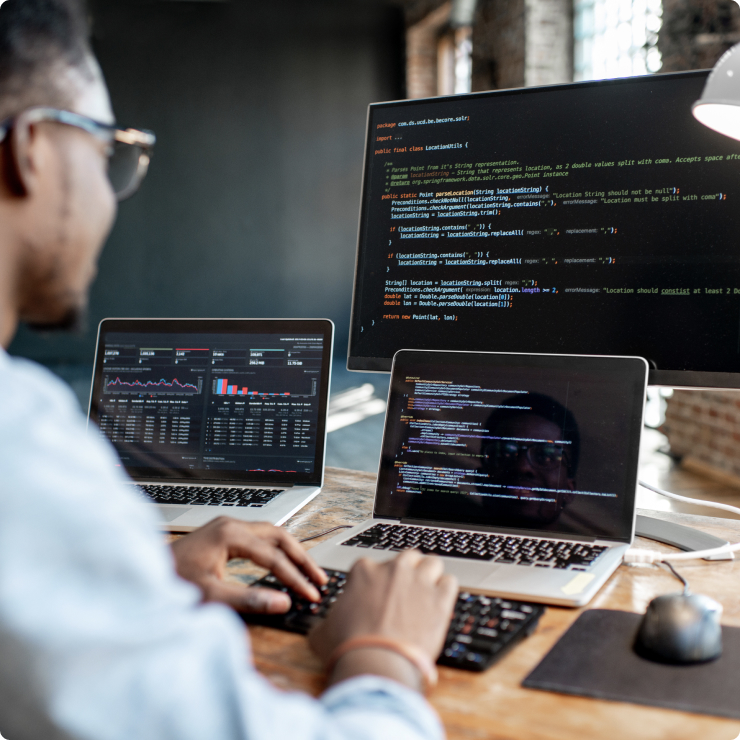 Developers coding on laptops at a desk