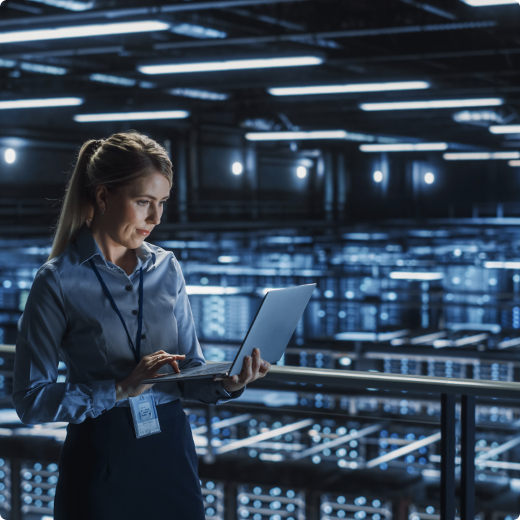 Woman with a laptop in a server room