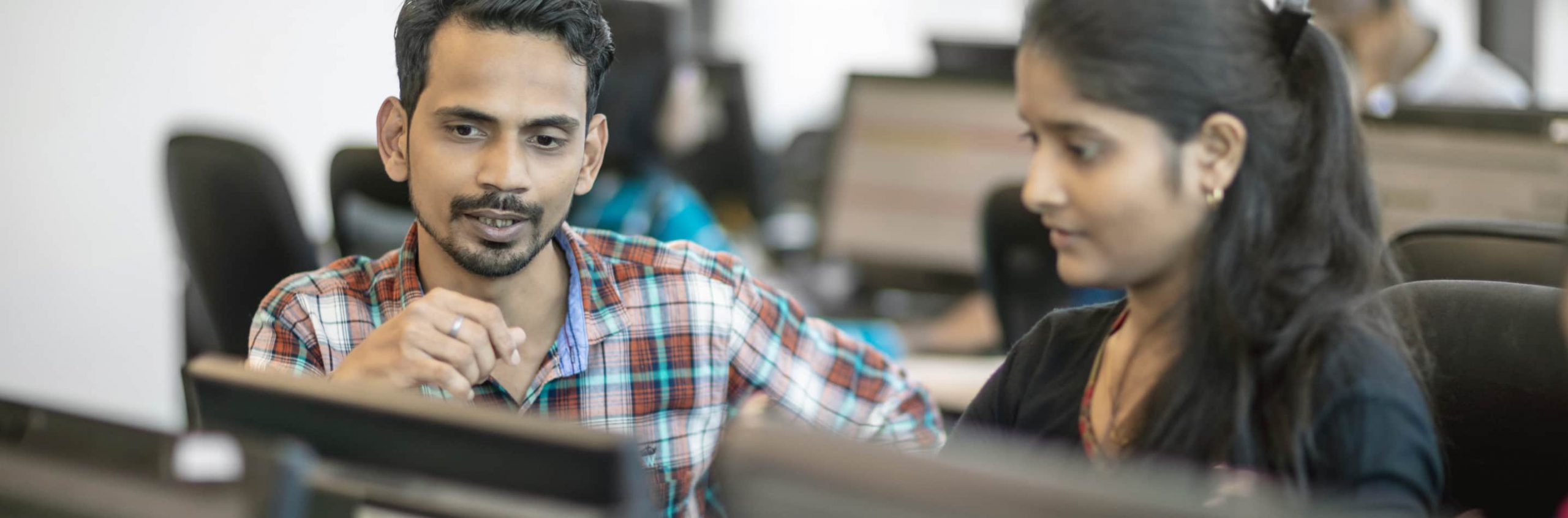 Two colleagues working at a computer