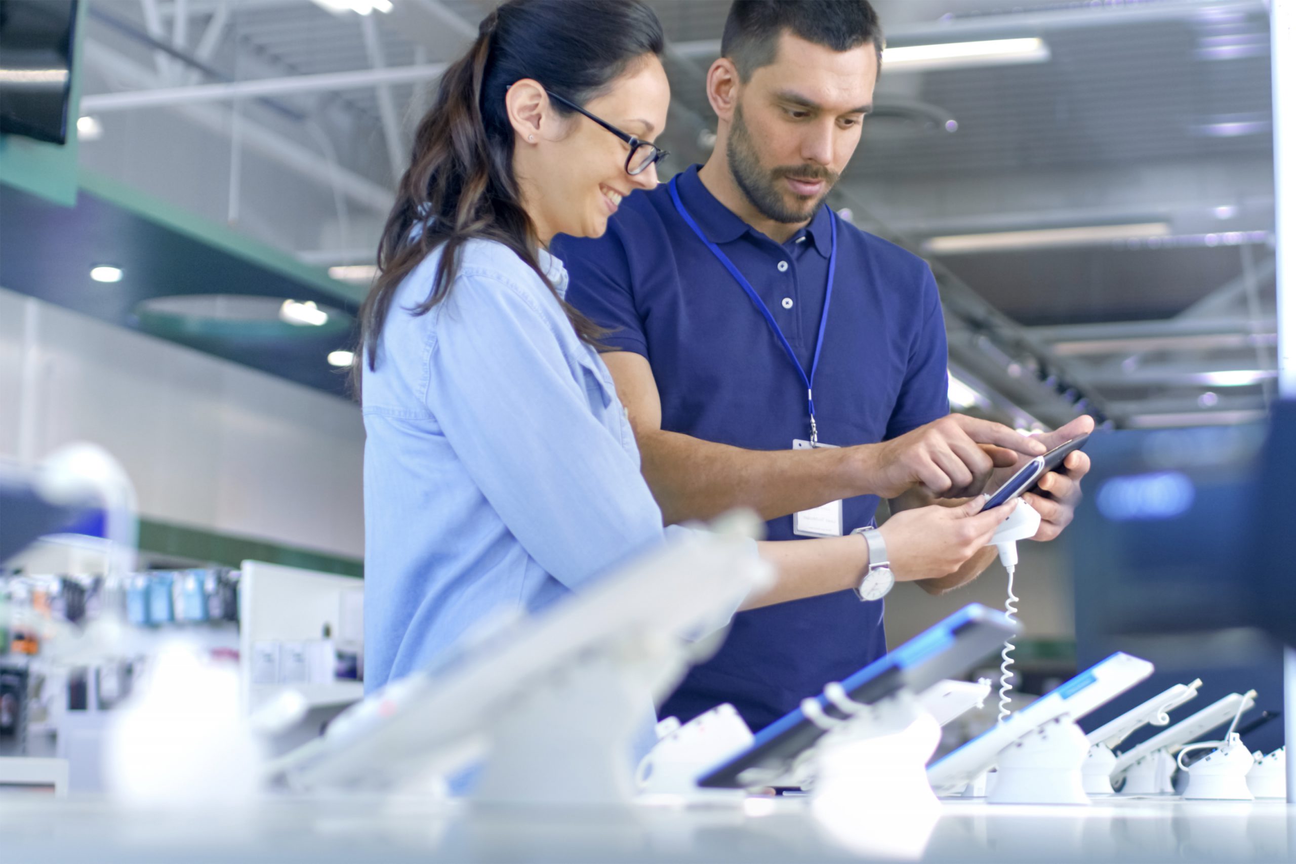 Two technicians checking devices in a telecommunications facility