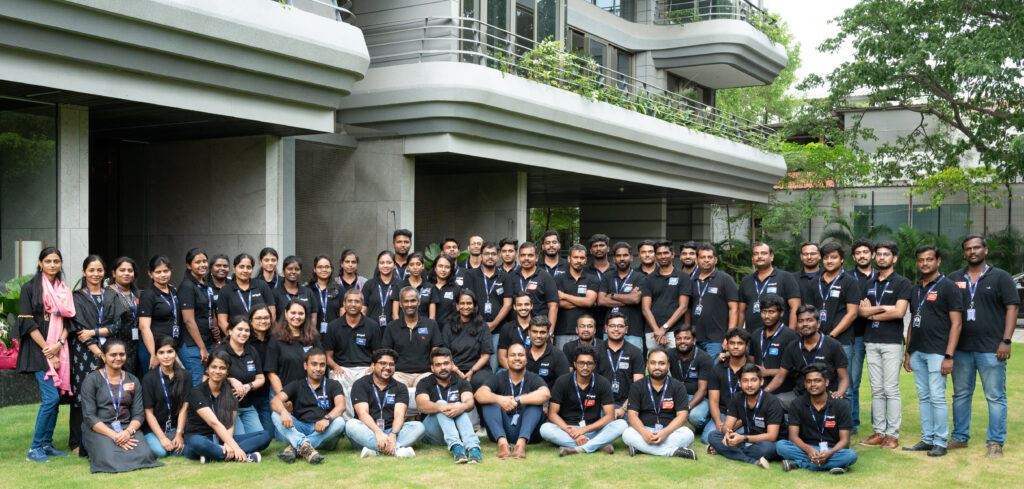 Propel team members posing in front of a building