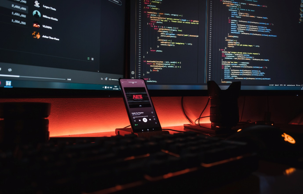 Developer screens showing code in a dark room