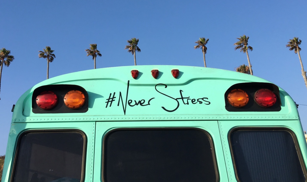 Teal bus with "#NeverStress" written on the back