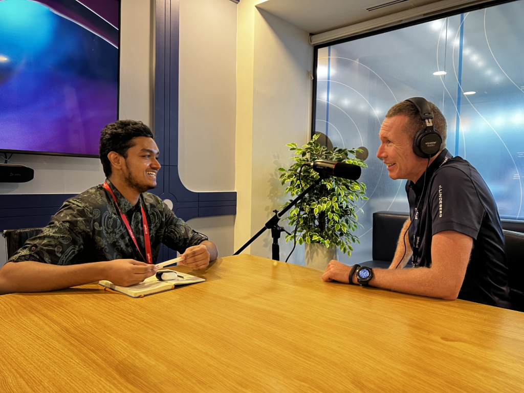 Two men talking across a table in a meeting room