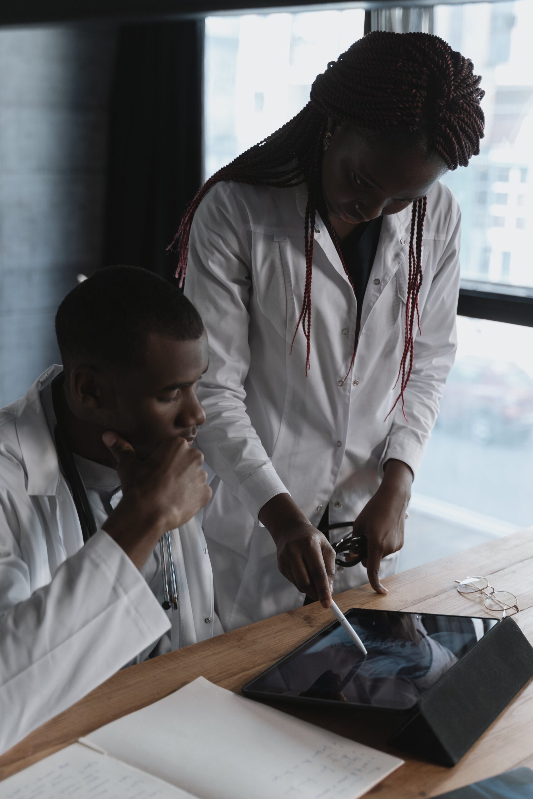 Lab technician in a white coat working with lab equipment