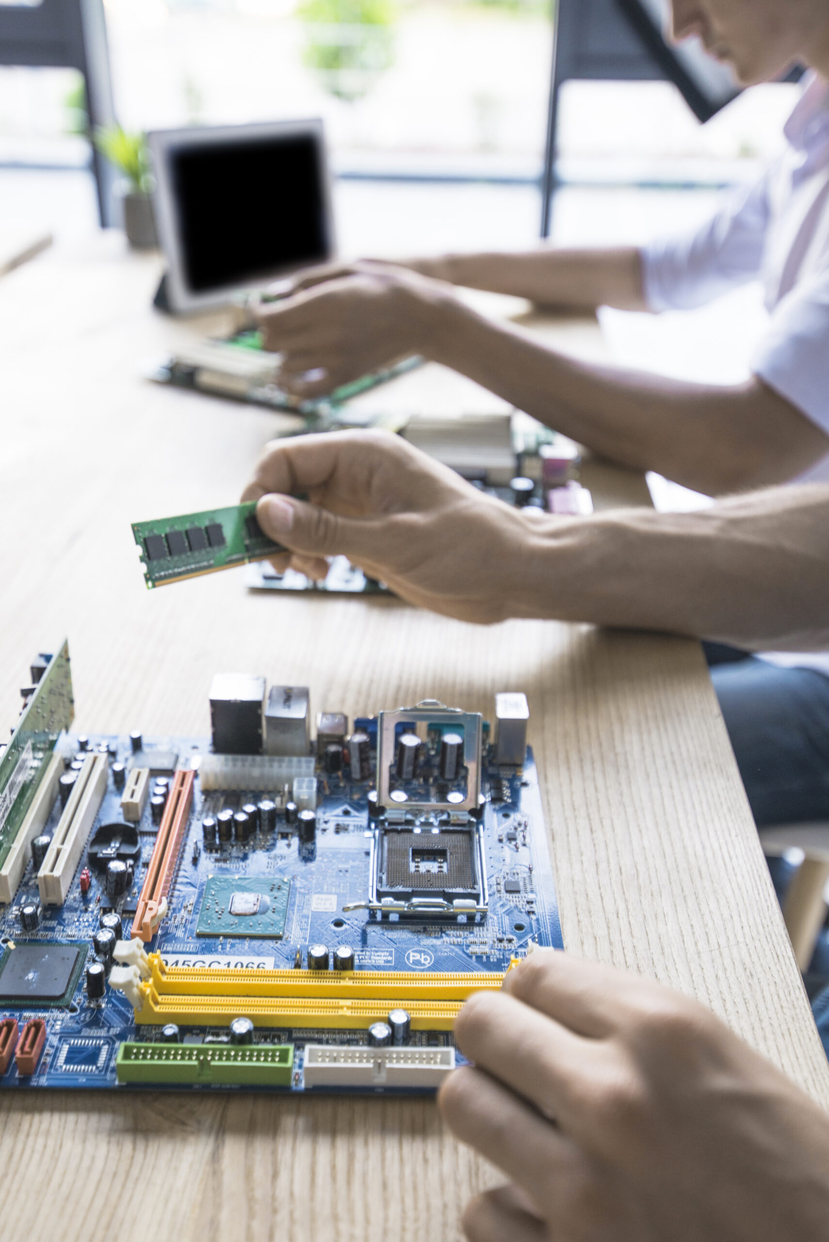 Hands working on an electronic circuit board