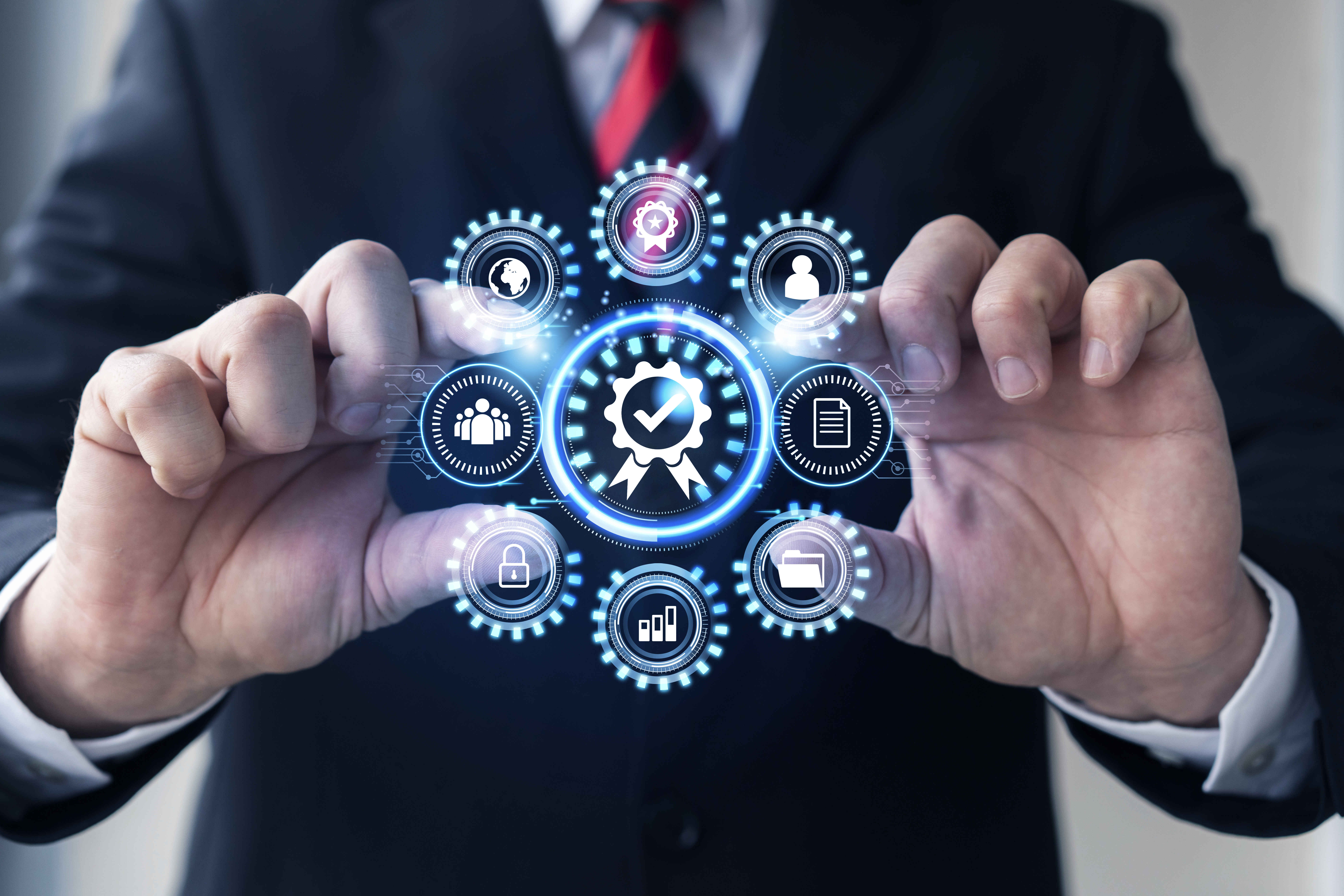 Hands holding a glowing icon hub of facility systems