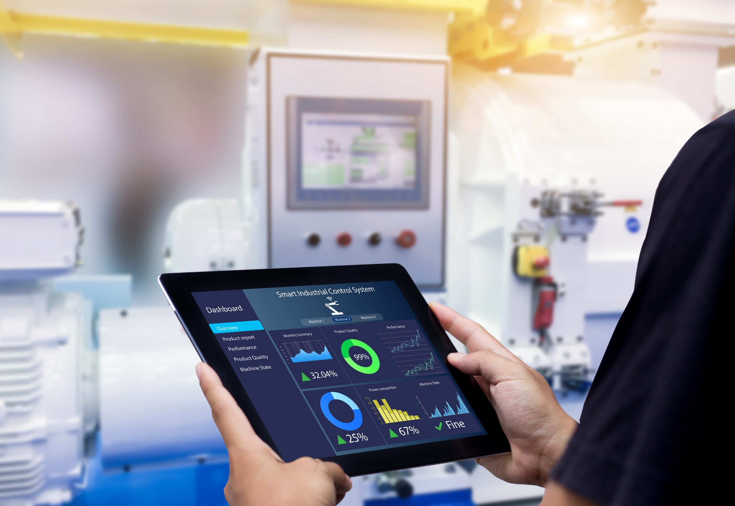 Hands holding a tablet showing an industrial dashboard