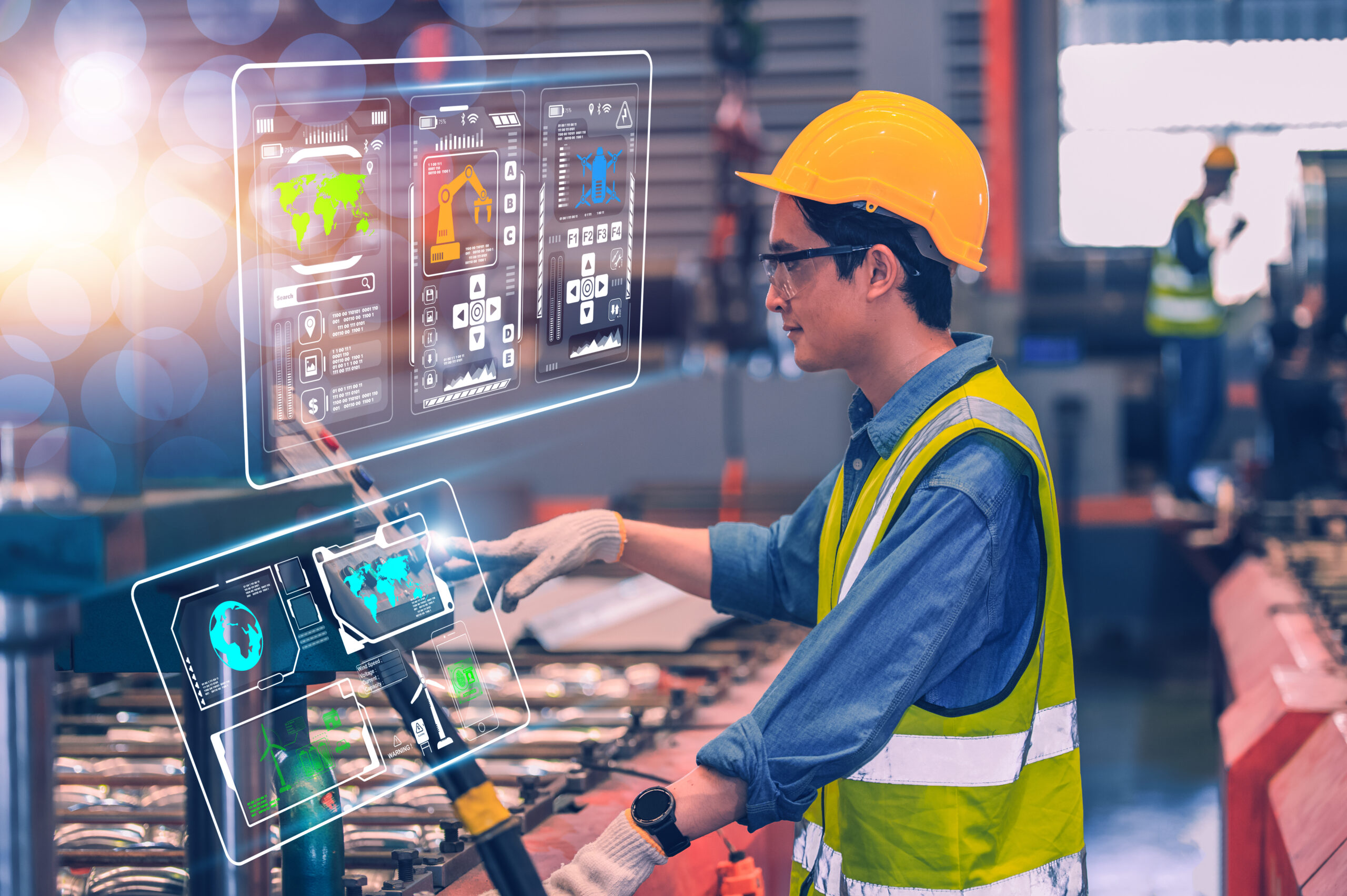Factory worker in a hard hat using a holographic control panel